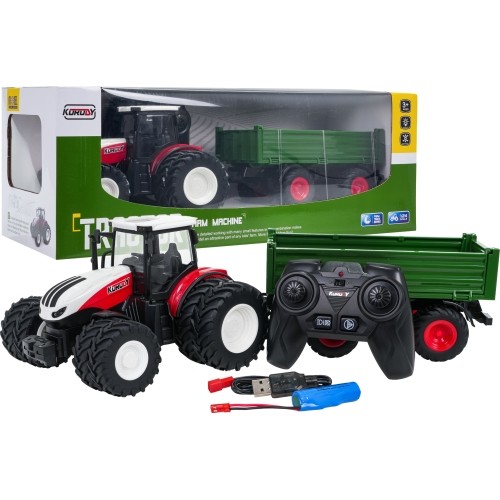 Czerwony traktor zdalnie sterowany z zieloną naczepą